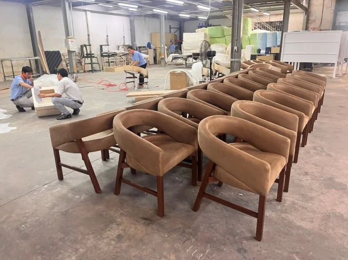 A row of upholstered chairs on the furniture production floor